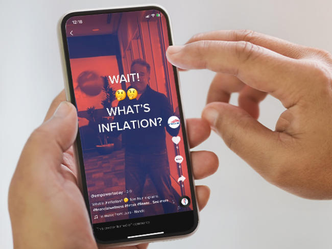 Image of a hand holing a phone, accessing TikTok